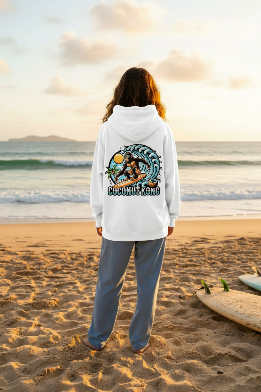 Woman in white Coconut Kong hoodie on beach